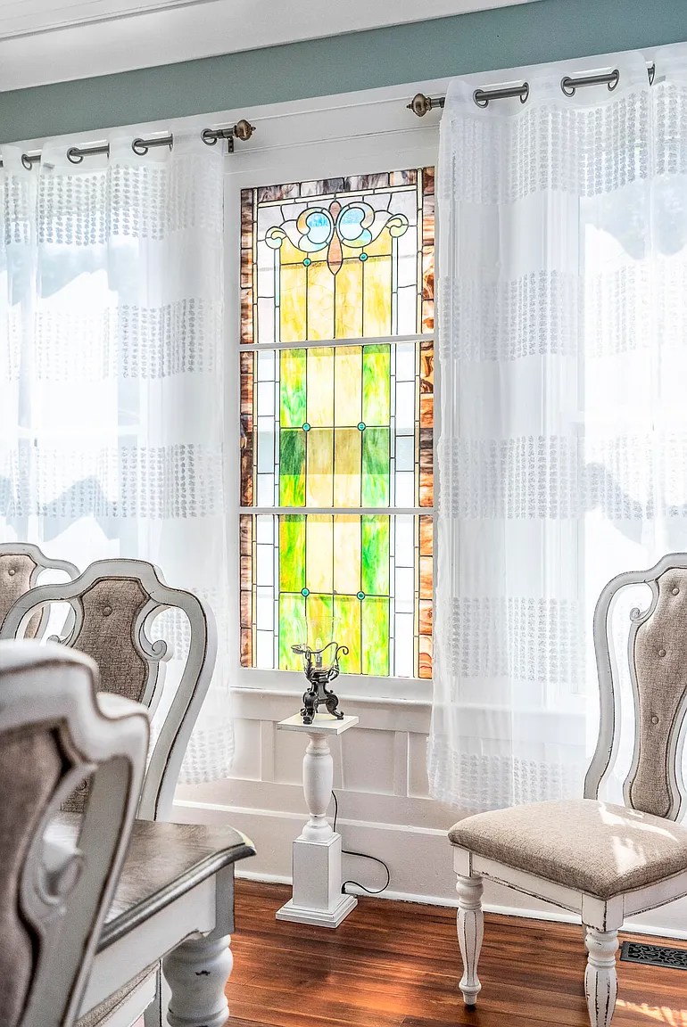 Vintage green stained glass dining room window with peach and red border