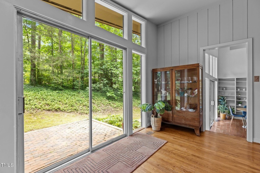 Light-filled mid-century modern living room with clerestory windows and step down into the dining area.