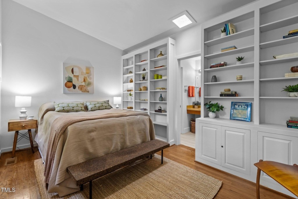 Bright bedroom in North Carolina mid-century modern house with built in bookshelves
