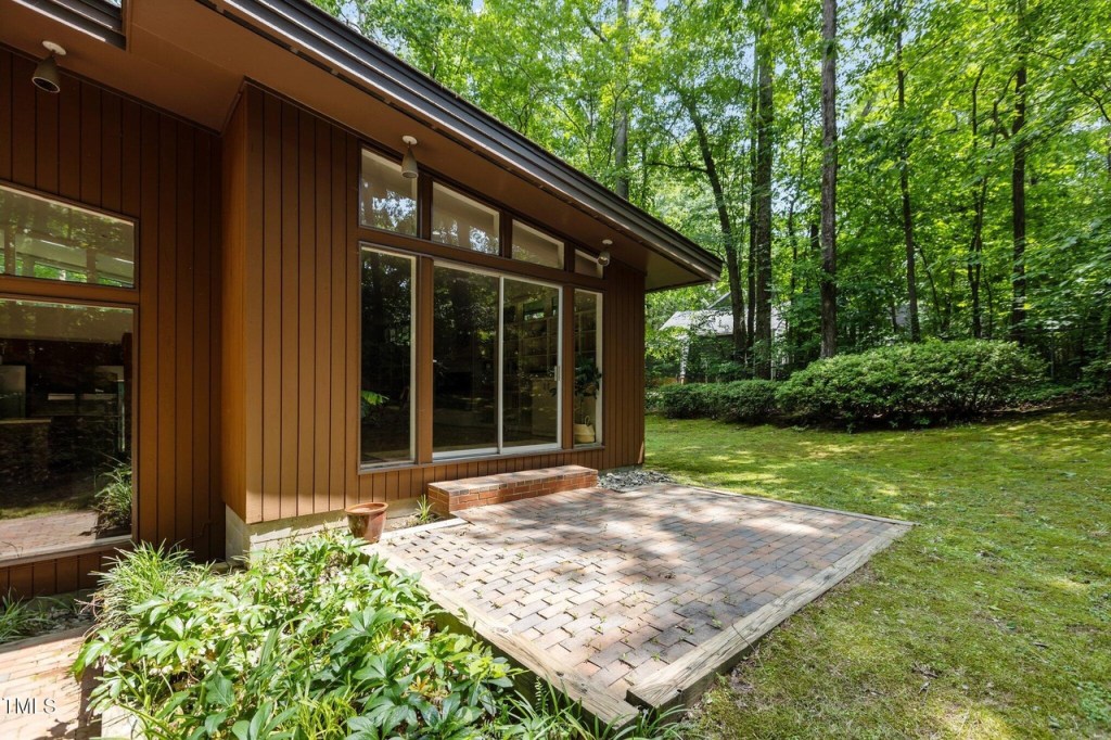 Private backyard of Durham mid-century modern home with natural landscaping

