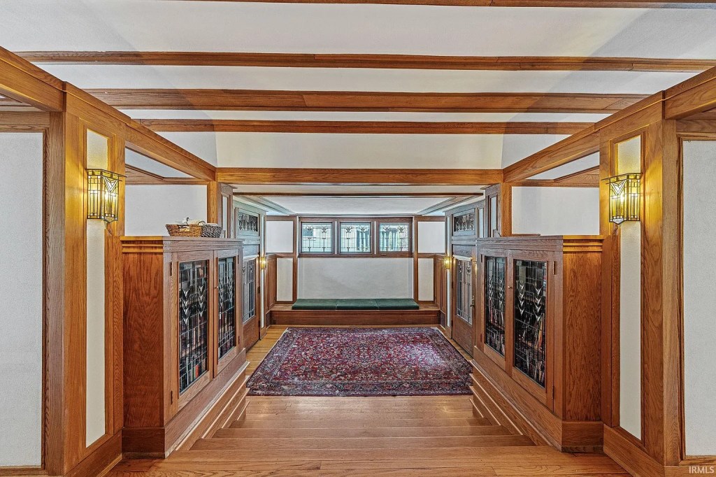 The inside of a home with wood floors and clerestory windows.