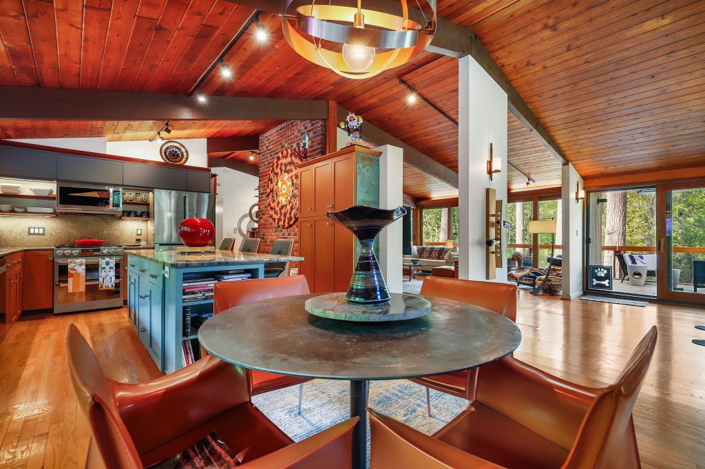 Open concept Mid-century kitchen with wood cabinetry and natural wood tones

