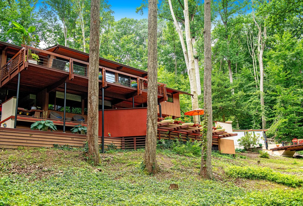Exterior of private 1971 Acorn Deck House in Towson Maryland surrounded by forest