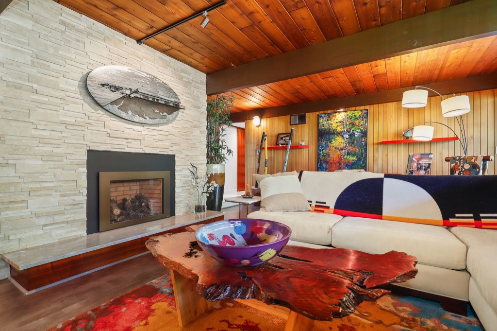 Cozy living space with fireplace and wood ceiling