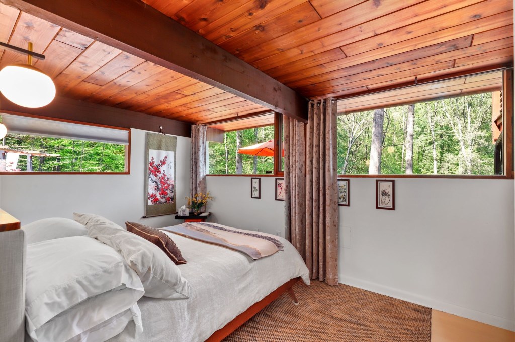 Forest-view bedroom with clerestory windows in Baltimore MCM home

