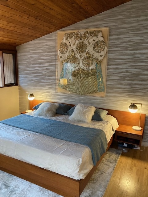 Forest-view bedroom with clerestory windows in Baltimore MCM home

