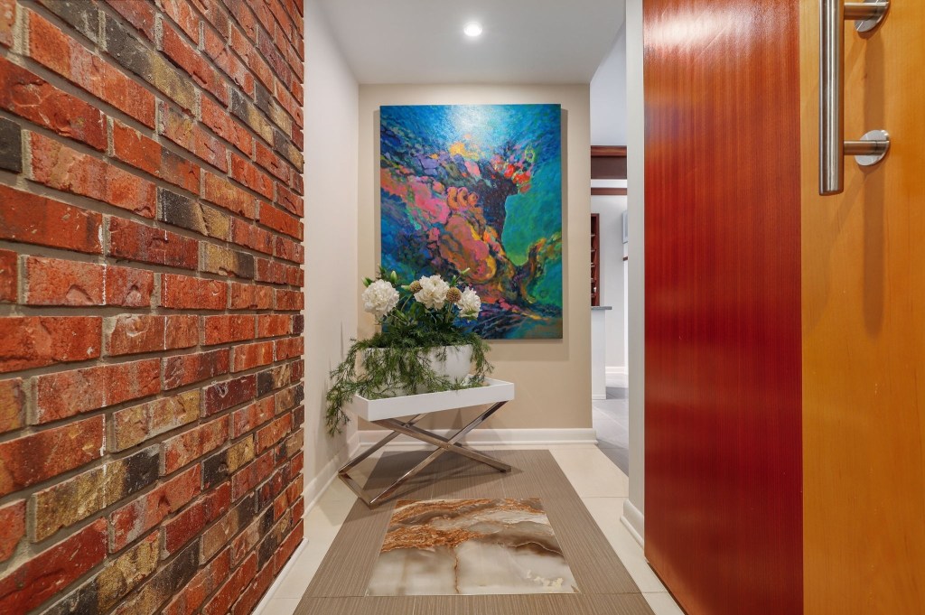 Hallway in mid century modern house with a brick accent wall