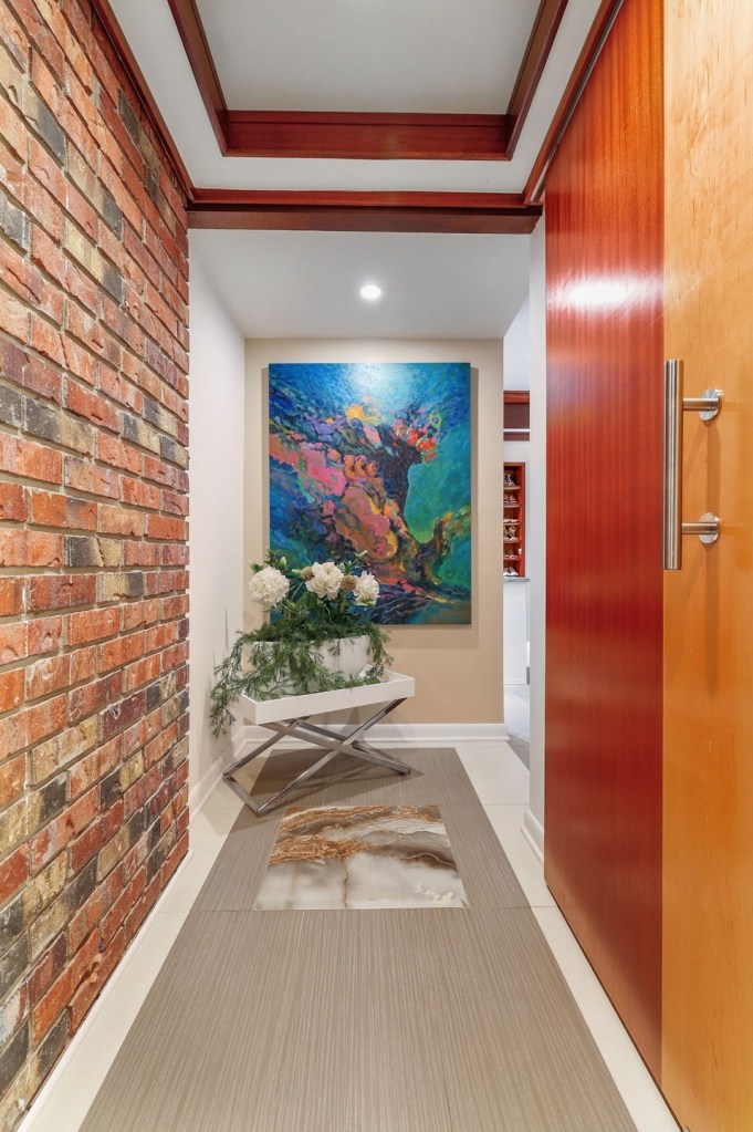 Hallway in mid century modern house with a brick accent wall