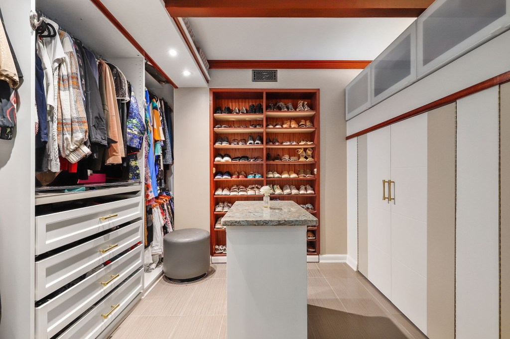 Large walk in closet with built in shoe rack in mid century modern house