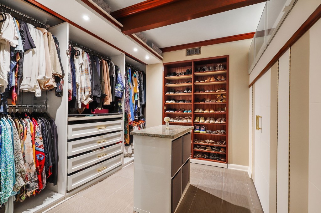 Large walk in closet with built in shoe rack in mid century modern house