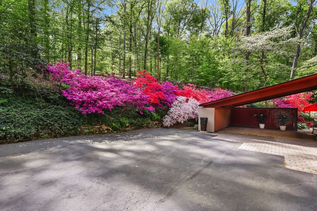 Mid-century modern Deck House with wood siding and geometric rooflines in Baltimore County


