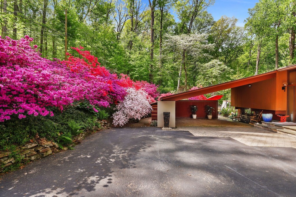 Mid-century modern Deck House with wood siding and geometric rooflines in Baltimore County

