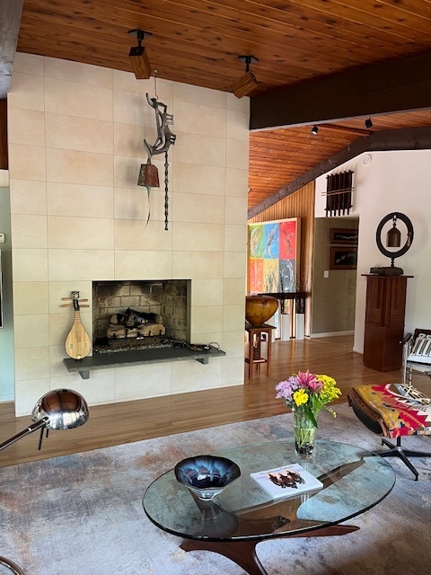 Cozy white fireplace in the living room of Towson deck house built in the 70s 

