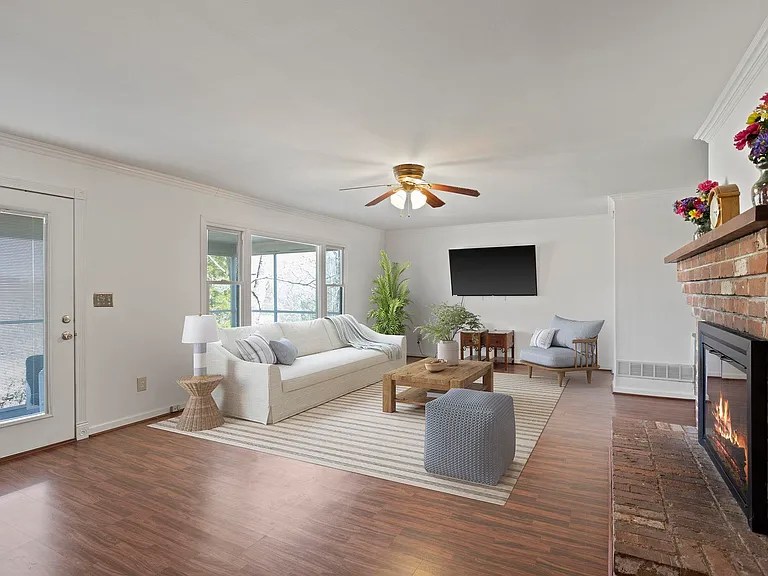 Bright and spacious living room with hardwood floors and natural light in Travelers Rest home

