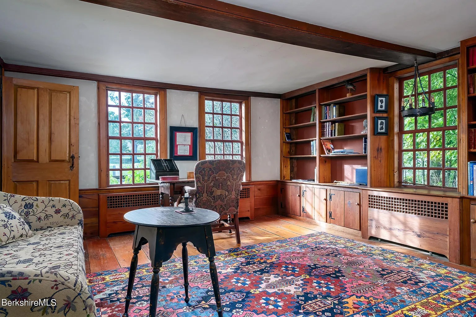 Sitting room in dark grey restored 18th-century Georgian home in Williamstown Massachusetts