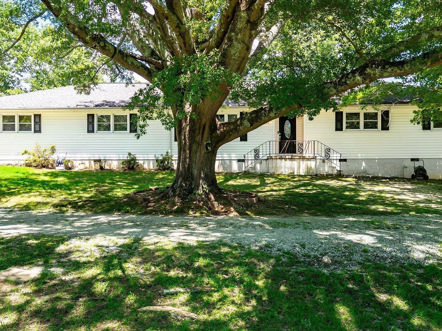 Peaceful Travelers Rest home surrounded by mature trees on five private acres