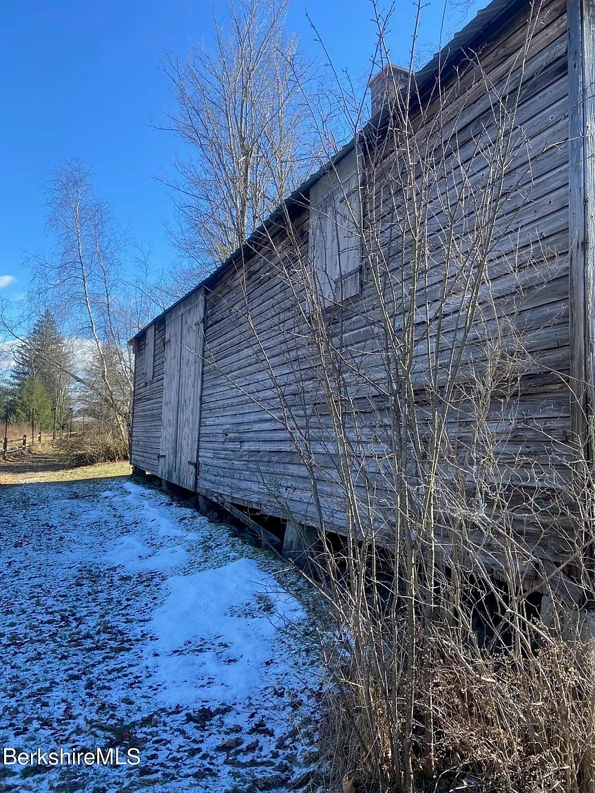 Side view of the barns and garage of 18th-century Georgian home in Williamstown Massachusetts