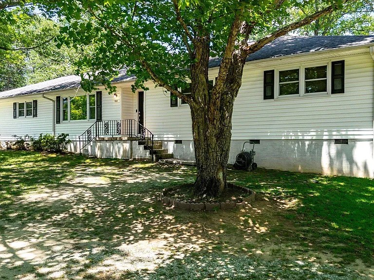 Peaceful Travelers Rest home surrounded by mature trees on five private acres