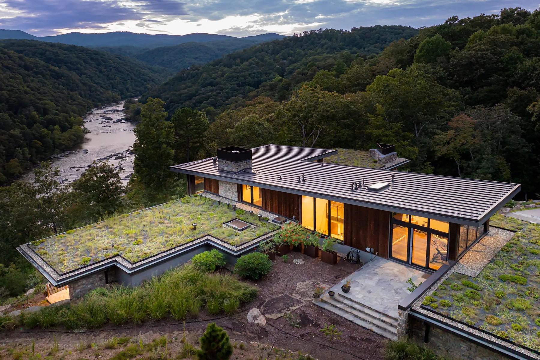 Sustainable living roof blending into the natural landscape of this North Carolina retreat

