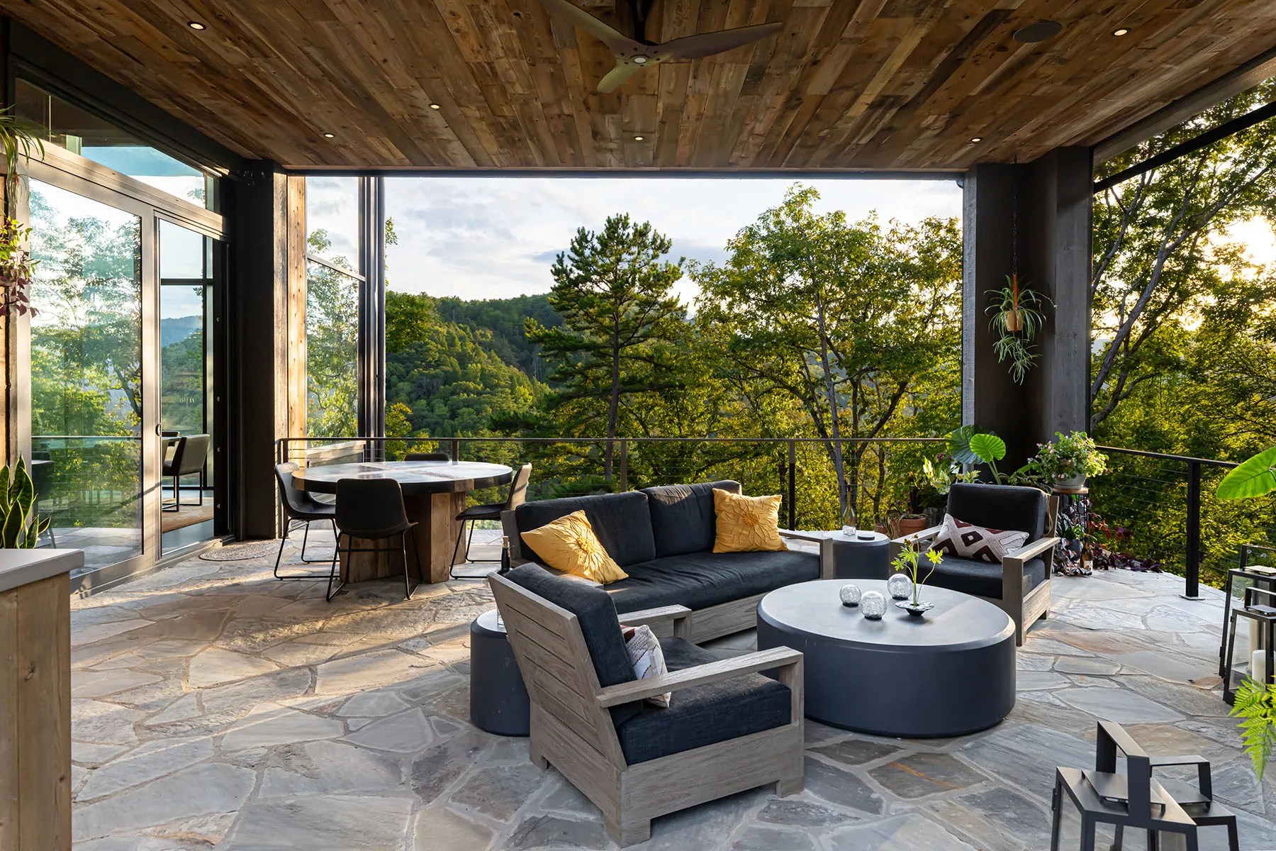 Covered patio area offering peaceful views of the forest and energy-efficient design features

