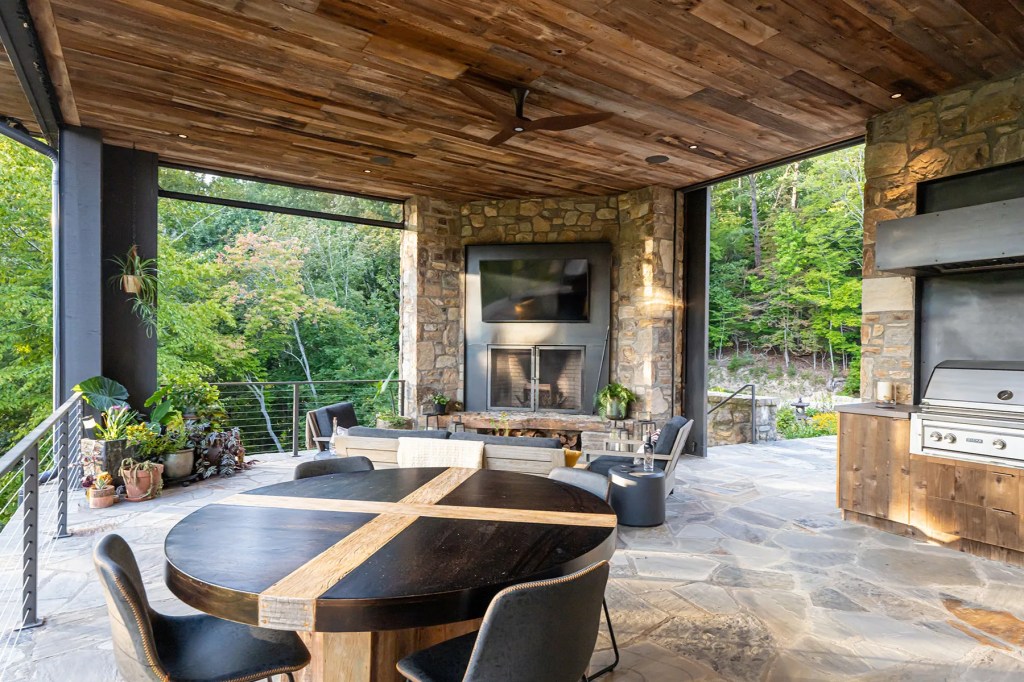 Covered patio area offering peaceful views of the forest and energy-efficient design features

